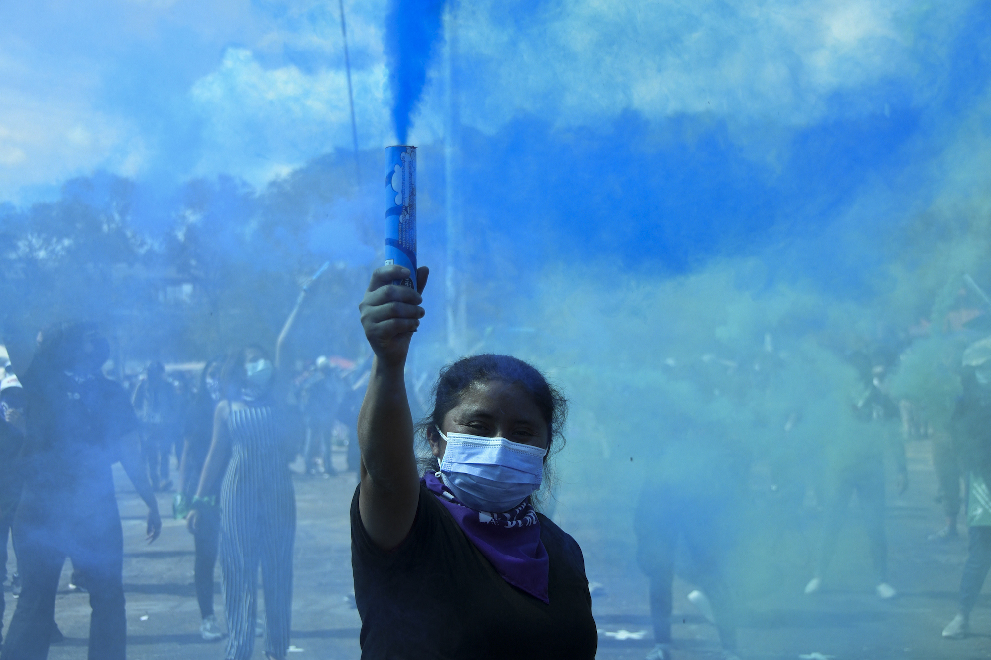Lady holding a blue flare